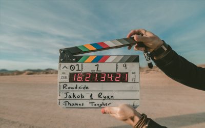 A film clapperboard held up in a desert landscape